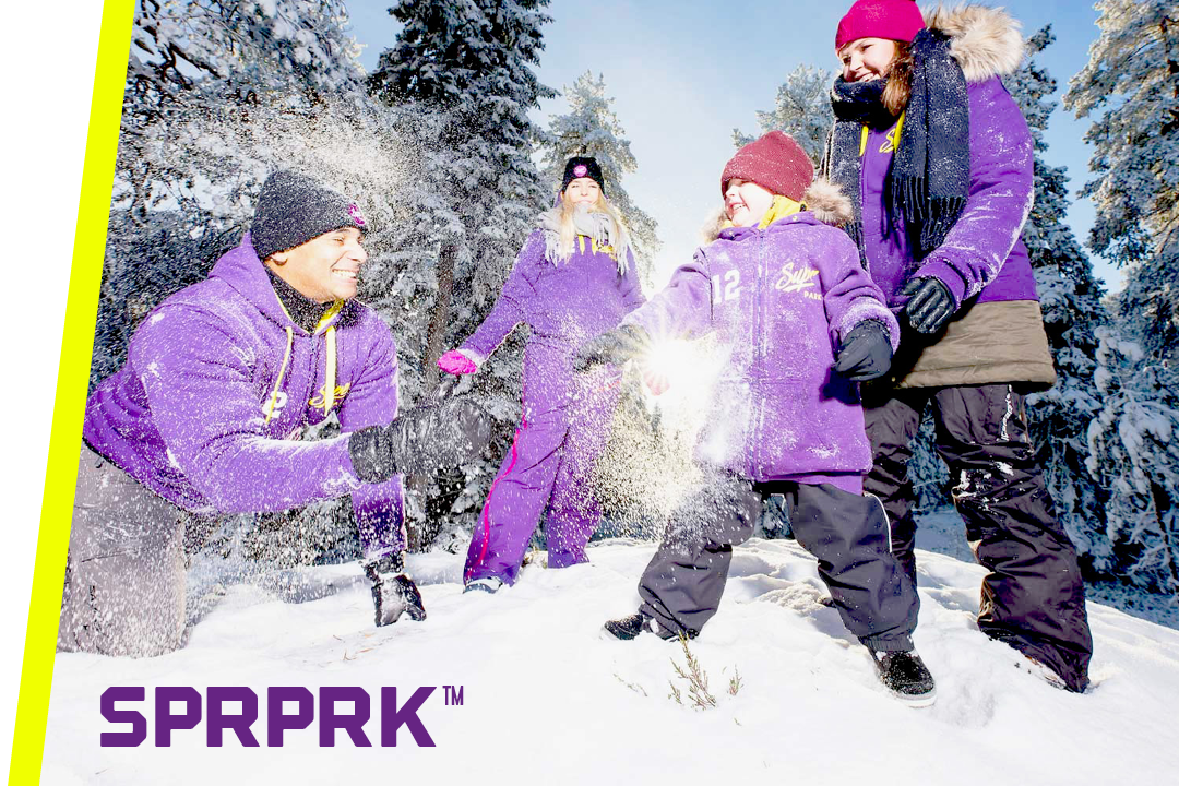 A family playing in the snow with the text SPRPRK™ in the corner